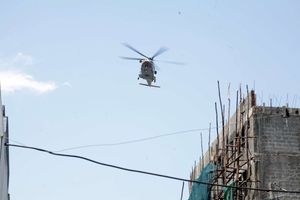 A helicopter flies over a part of Kisumu. 