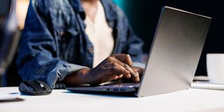 woman at the desk typing on her personal computer