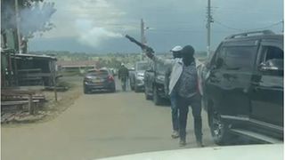 A screengrab of a video of armed men arriving at a polling station in Ol Kalou.