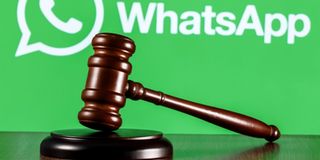 Gavel on table against background of Whatsapp 