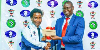 Chess Kenya president Benard Wanjala rewards Barry Hawi Kaloki 