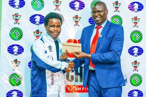 Chess Kenya president Benard Wanjala rewards Barry Hawi Kaloki 