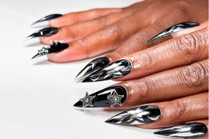 Woman's hand with black chrome nails