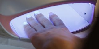 Curing Gel Nails Under UV Lamp in Nail Salon
