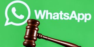 Gavel on table against background of Whatsapp 