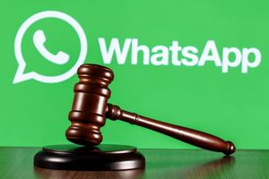 Gavel on table against background of Whatsapp 