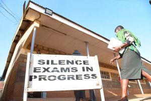 A KCSE invigilator enters an exam hall at Uasin Gishu High School