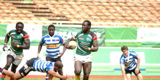 Kenya Shujaa's Billy Odhiambo evades a tackle from Western Province's Andre Smith